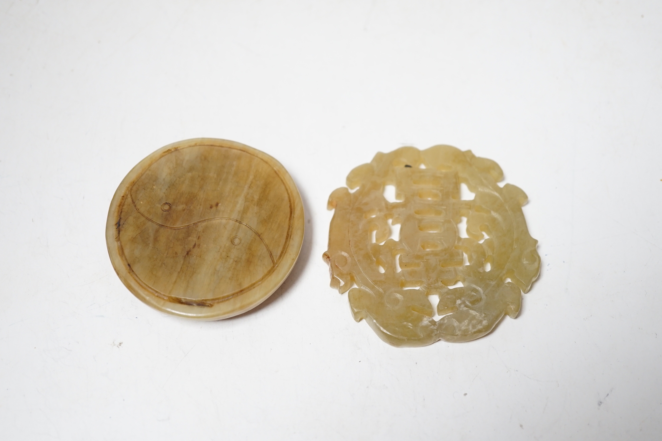 Two Chinese carved bowenite jade discs, largest 6cm diameter